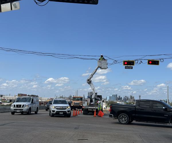 Span-wire signal work under traffic control