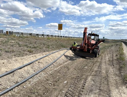 Trenching conduit along the freeway